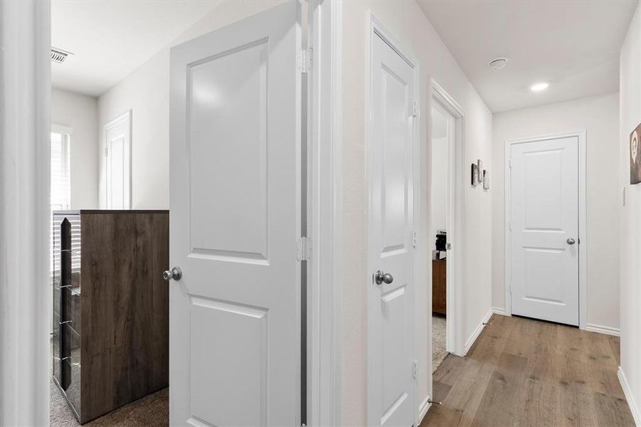 Corridor with dark wood-type flooring and recessed lighting Corridor with dark wood-type flooring and recessed lighting