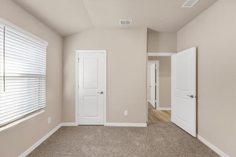 Unfurnished bedroom featuring carpet flooring and baseboards Unfurnished bedroom featuring carpet flooring and baseboards
