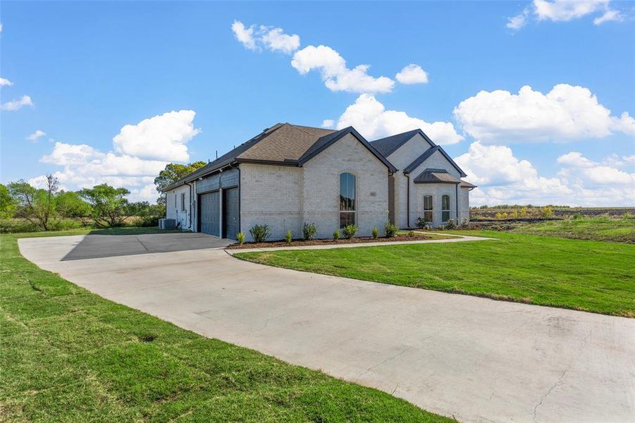 French provincial home featuring a front lawn