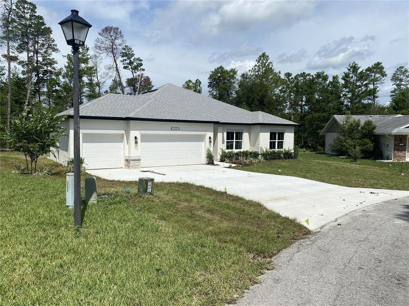 Front exterior of a new home in , Citrus Springs, FL, highlighting curb appeal (Image 2). Front exterior of a new home in , Citrus Springs, FL, highlighting curb appeal (Image 2).