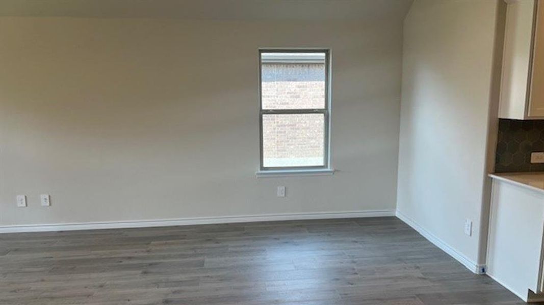 Spare room featuring light wood finished floors and baseboards Spare room featuring light wood finished floors and baseboards