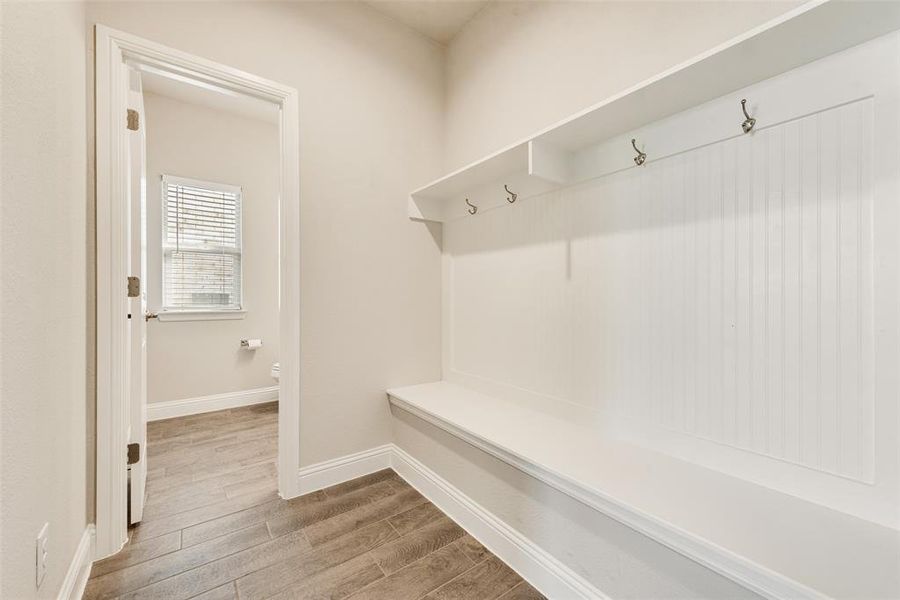 Mudroom with baseboards and light wood-style flooring