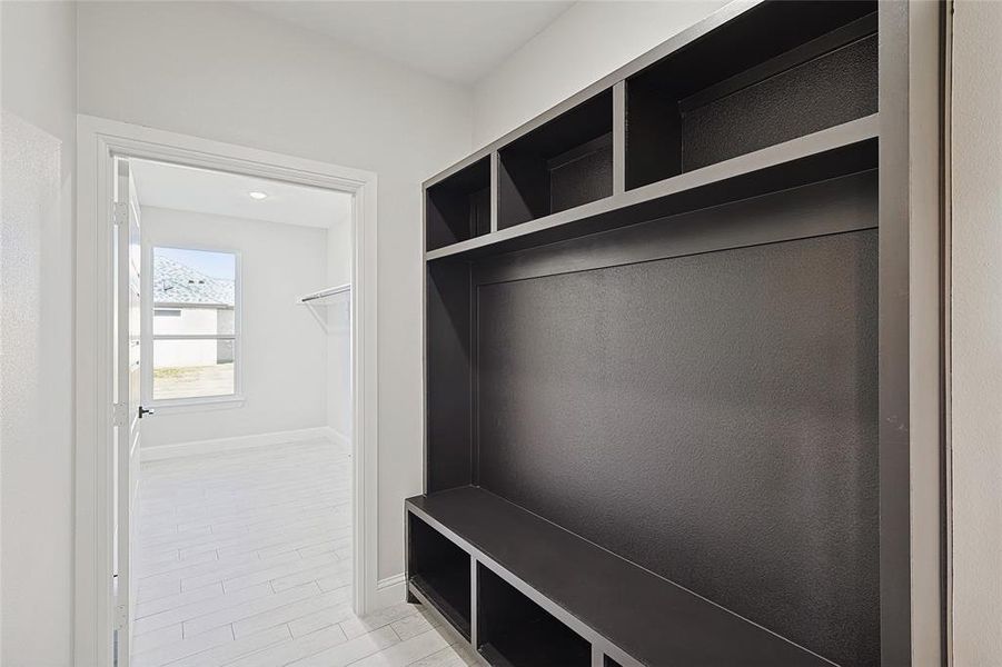 Mudroom with light hardwood / wood-style floors