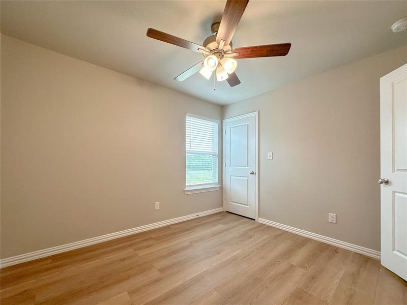 Empty room featuring light hardwood / wood-style flooring and ceiling fan