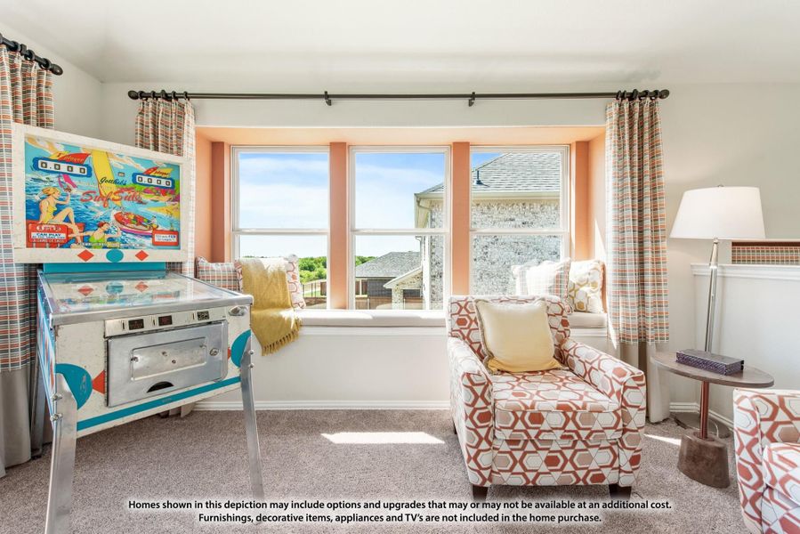 Bonus room with vintage pinball machine, patterned armchair, window seat, and large windows with neighborhood view Bonus room with vintage pinball machine, patterned armchair, window seat, and large windows with neighborhood view