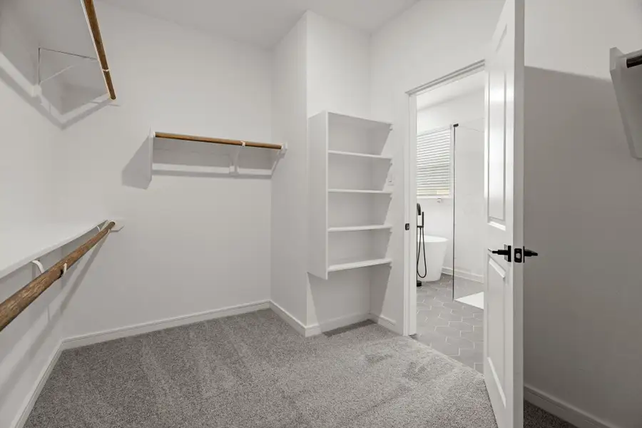 Walk-in closet in primary suite (*Photo not of actual home and used for illustration purposes only.) Walk-in closet in primary suite (*Photo not of actual home and used for illustration purposes only.)