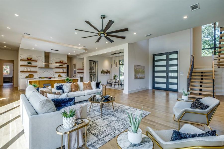 Living room featuring ceiling fan and light wood-type flooring