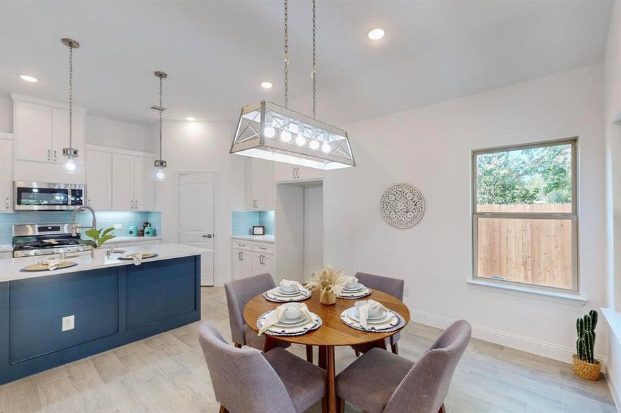 Dining space with light hardwood / wood-style flooring