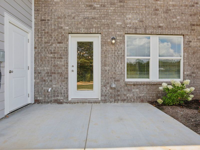 Exterior details and patio area of a home in Cedarcrest Townhomes, Fairview (Image 2).