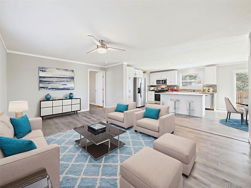 Virtually Staged Back Family Room – Furnished for maximum comfort, this back living space offers large windows, a neutral palette, and direct access to the hallway and bedroom areas.