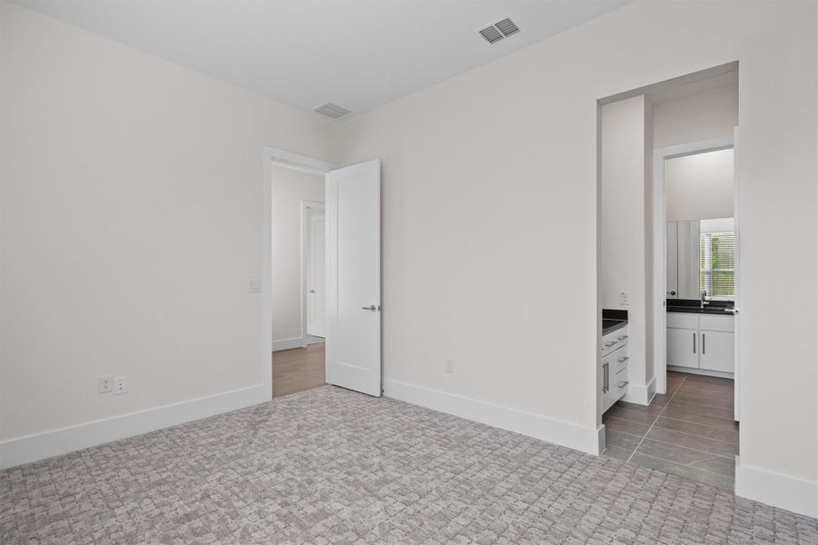 Unfurnished bedroom featuring baseboards and light colored carpet Unfurnished bedroom featuring baseboards and light colored carpet