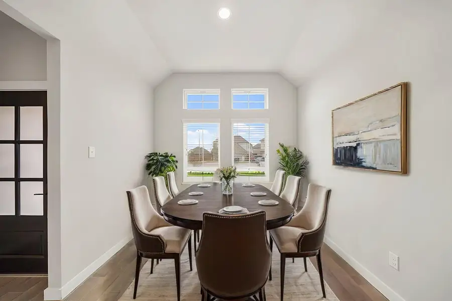 Virtually Staged: Spacious dining room with tile floors, large windows allowing plenty of natural light, and it has direct access to the kitchen.