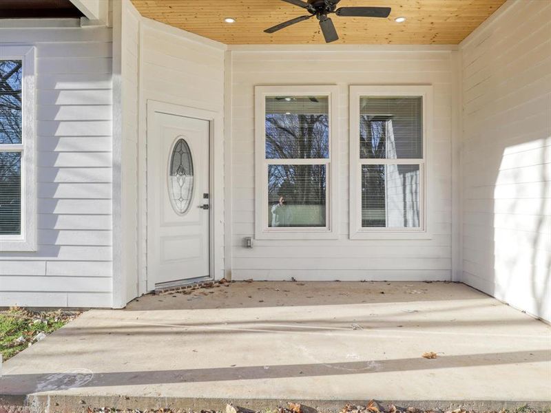 Doorway to property with ceiling fan and a patio area Doorway to property with ceiling fan and a patio area