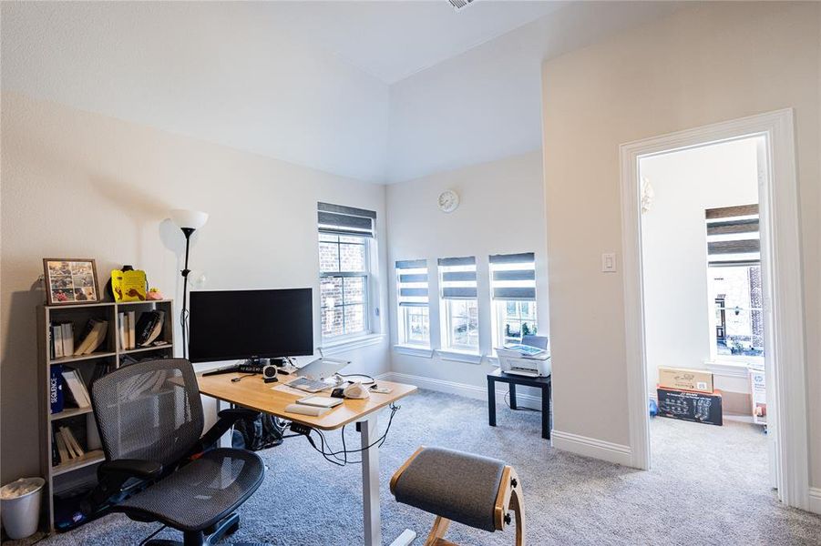 Office area with light carpet and baseboards