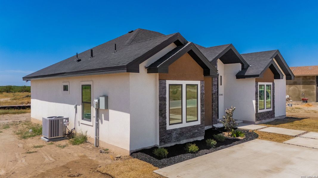 Front exterior of a new home in , Eagle Pass, TX, highlighting curb appeal (Image 21).