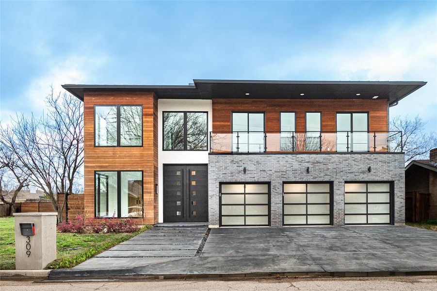 Modern home featuring a balcony and a garage