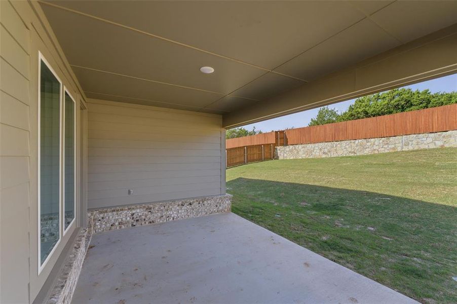 Fenced backyard with a patio area