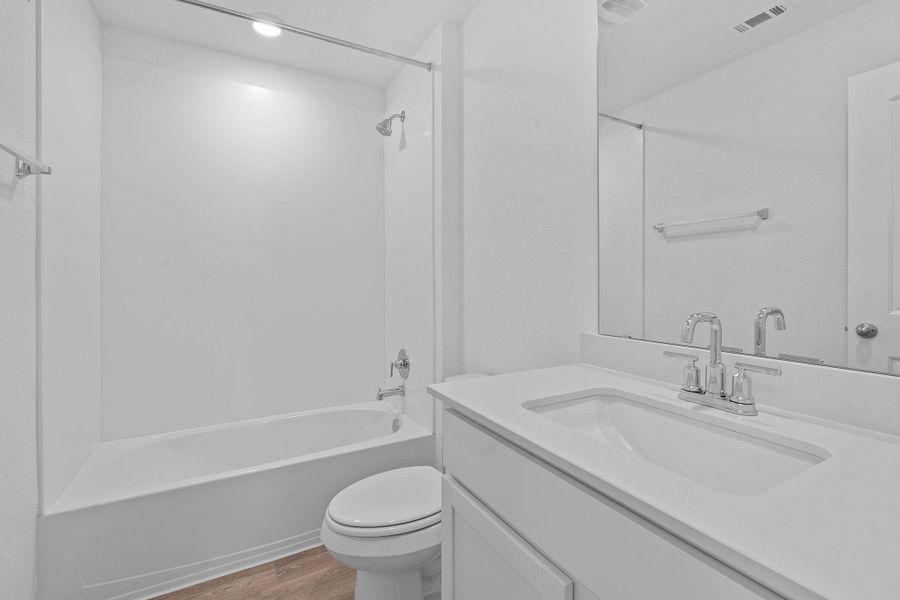 Bathroom with shower / bath combination, light wood finished floors, and vanity Bathroom with shower / bath combination, light wood finished floors, and vanity