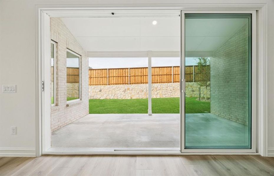 Large sliding glass door opens to a private patio