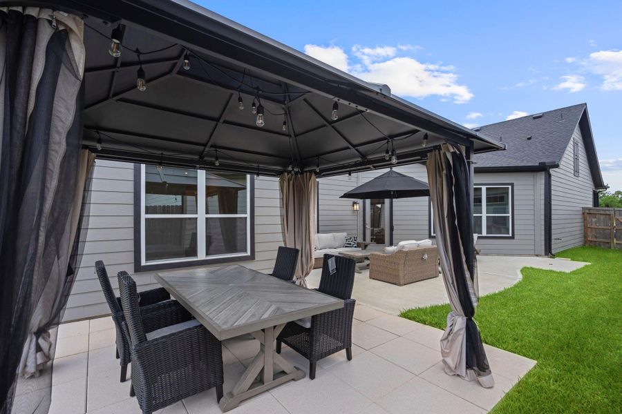 Enjoy peaceful outdoor living in the private courtyard of the Promenade III, perfect for morning coffee, gardening, or relaxing with friends and family. Image depicts home as-is.