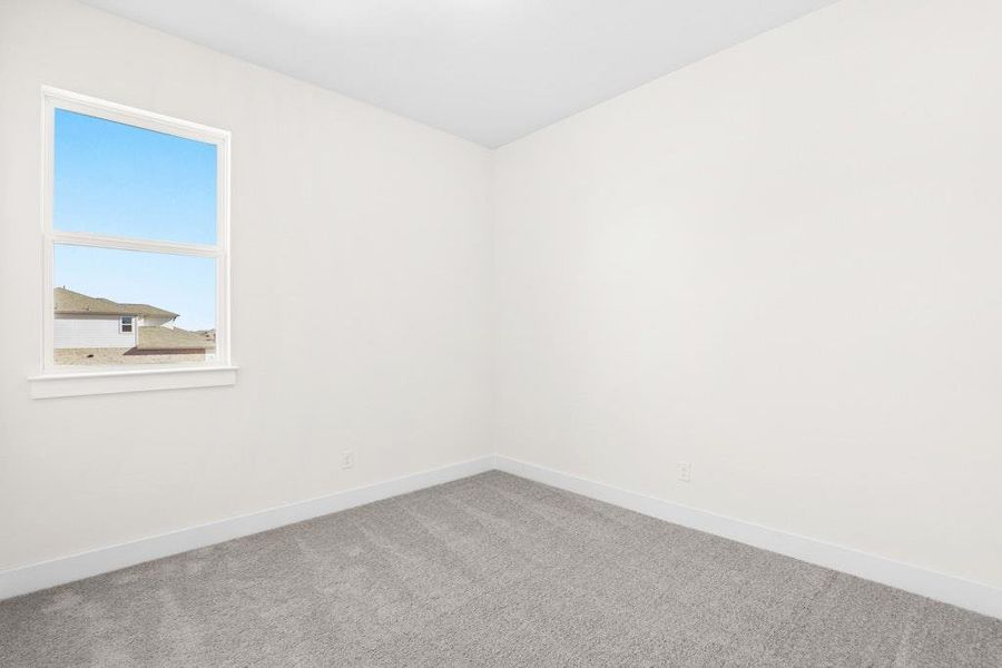 Spare room featuring carpet flooring and baseboards Spare room featuring carpet flooring and baseboards