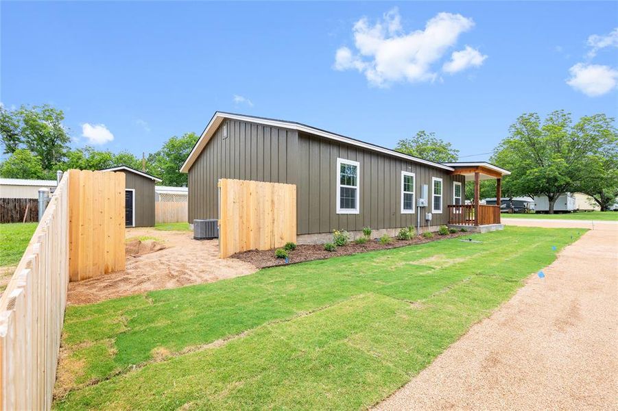 View of side of home featuring board and batten siding and central AC unit View of side of home featuring board and batten siding and central AC unit