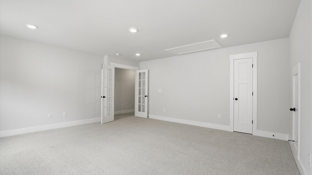Vibrant carpeted bonus room offering flexibility as a study nook, game room, or second family space in Anderson, SC