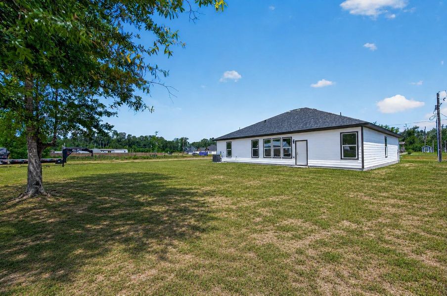 Spacious backyard with endless possibilities for outdoor entertaining, play areas, gardening, or future customization.