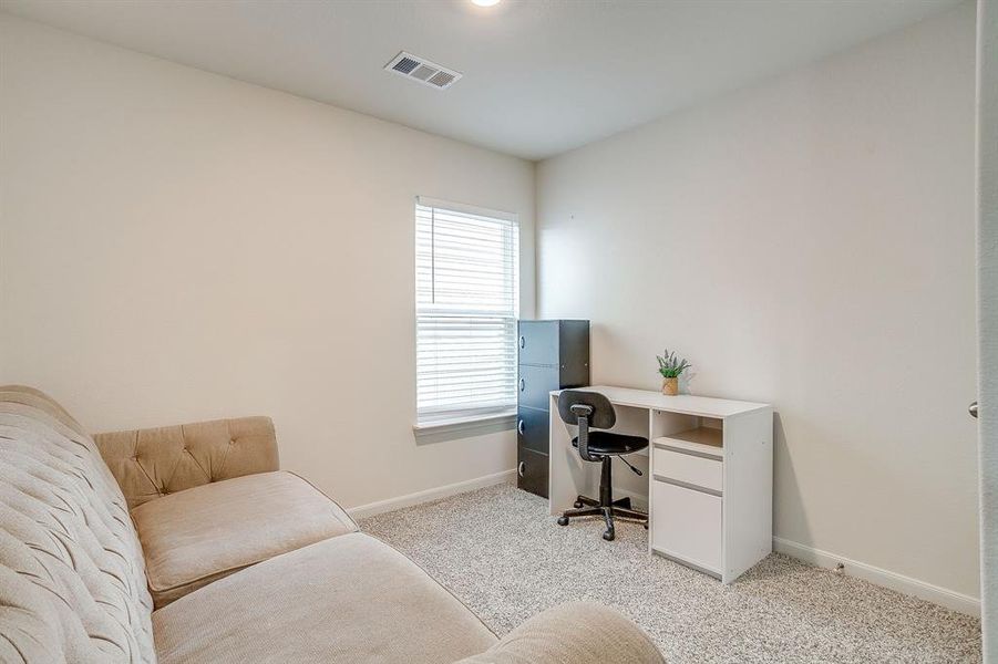 Office area featuring baseboards and light carpet