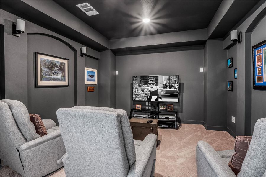 Carpeted home theater featuring baseboards Carpeted home theater featuring baseboards