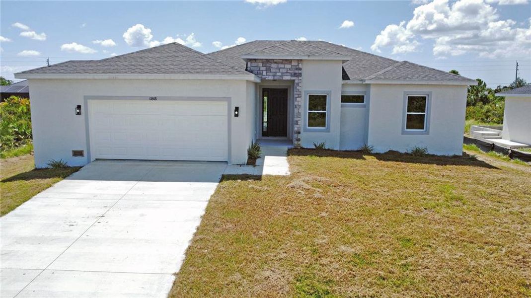 Front exterior of a new home in , Port Charlotte, FL, highlighting curb appeal (Image 1).