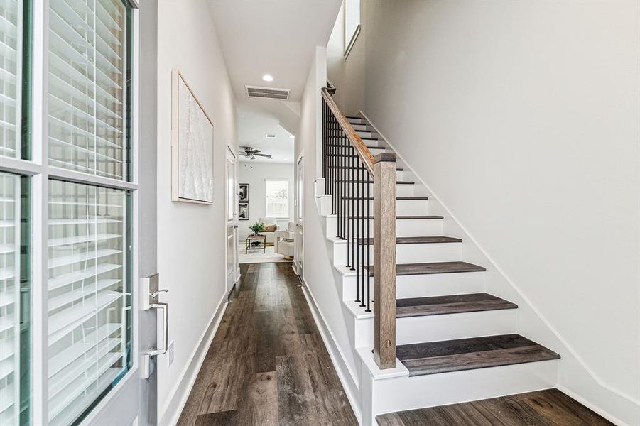 Step inside and be greeted by high ceilings, LED recessed can lighting, soothing paint colors and stylish wood railing with iron spindles on the stairway.