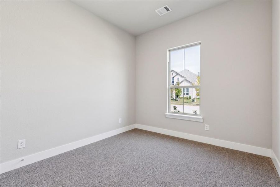 Carpeted spare room with baseboards