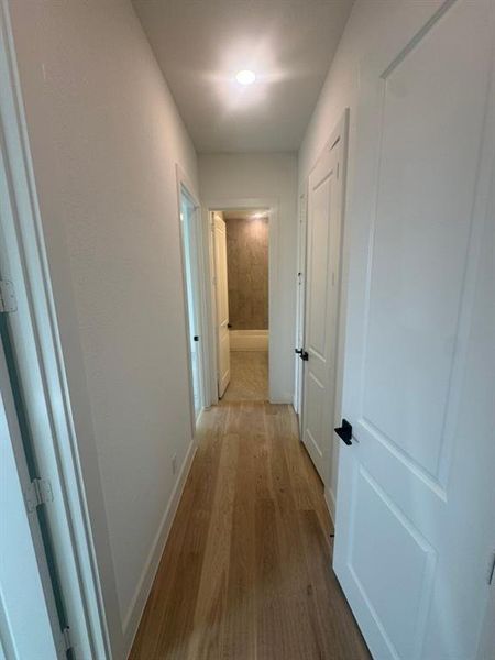 Hallway featuring wood-finish flooring and recessed ceiling lighting