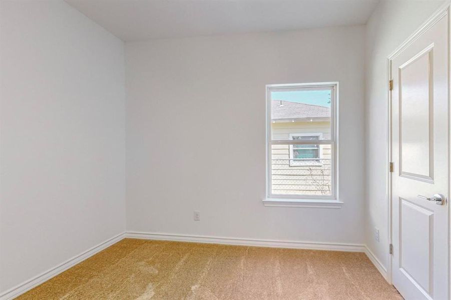 Spare bedroom #2 featuring light colored carpet