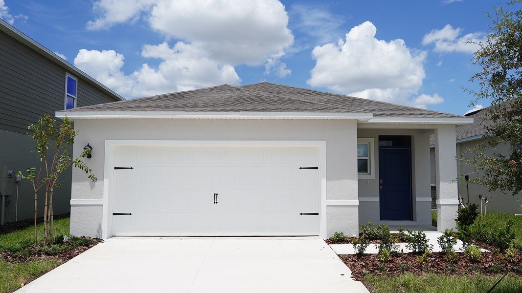 Front exterior of a new home in Villamar, Winter Haven, FL, highlighting curb appeal (Image 1).
