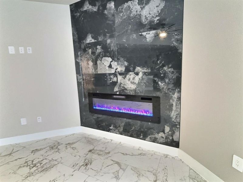Detailed view of baseboards and a fireplace