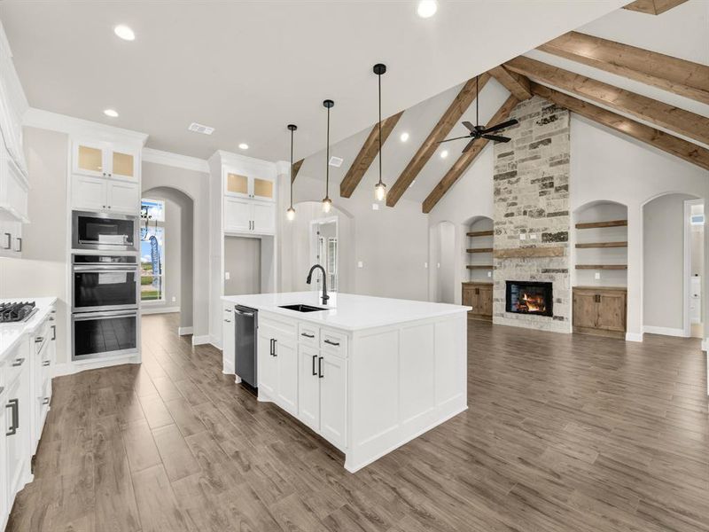 Kitchen featuring a sink, arched walkways, appliances with stainless steel finishes, recessed lighting, and light countertops Kitchen featuring a sink, arched walkways, appliances with stainless steel finishes, recessed lighting, and light countertops