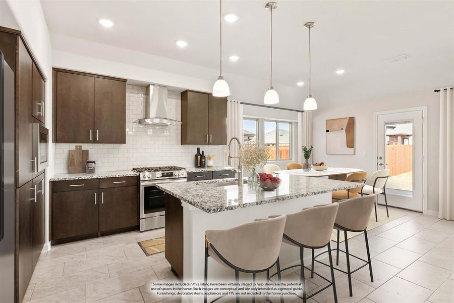 Kitchen with dark wood cabinets, granite island with bar seating, and stainless steel appliances