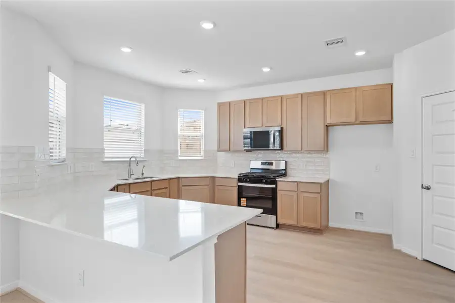This spacious kitchen has it all—ample storage, generous counter space, windows that brighten up the kitchen with natural lighting, and a layout that truly makes it the heart of the home. This spacious kitchen has it all—ample storage, generous counter space, windows that brighten up the kitchen with natural lighting, and a layout that truly makes it the heart of the home.