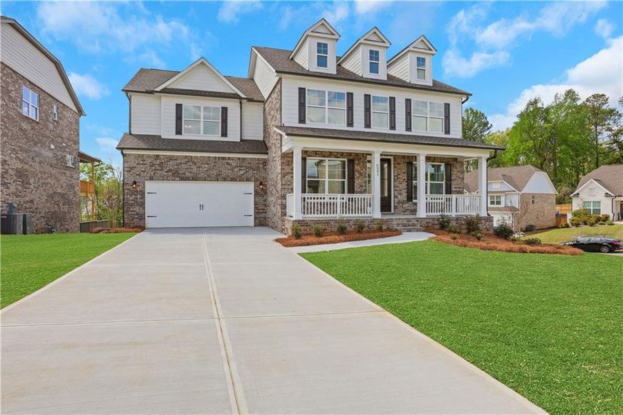 Front exterior of a new home in Cambridge, Flowery Branch, GA, highlighting curb appeal (Image 1). Front exterior of a new home in Cambridge, Flowery Branch, GA, highlighting curb appeal (Image 1).