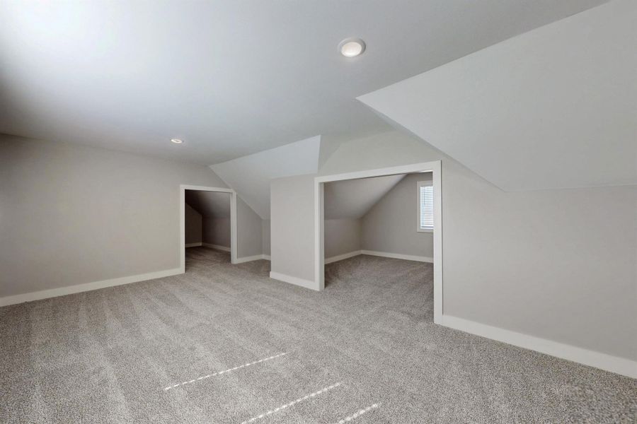 The stairwell to the bonus room is located off the garage. The builder designed it for storage but it could certainly be converted to another bedroom, craft room, sewing room, game room. The bonus room is the only thing upstairs and has 3 sections.