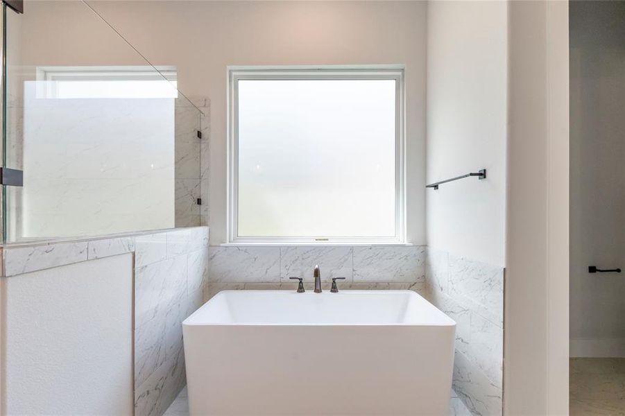 Bathroom featuring tile walls and tile patterned flooring