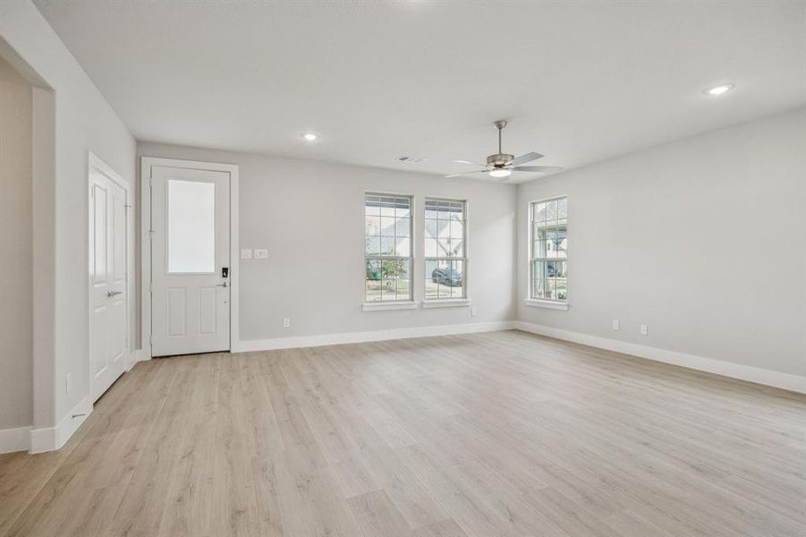 Unfurnished living room with light wood-style floors and recessed lighting Unfurnished living room with light wood-style floors and recessed lighting