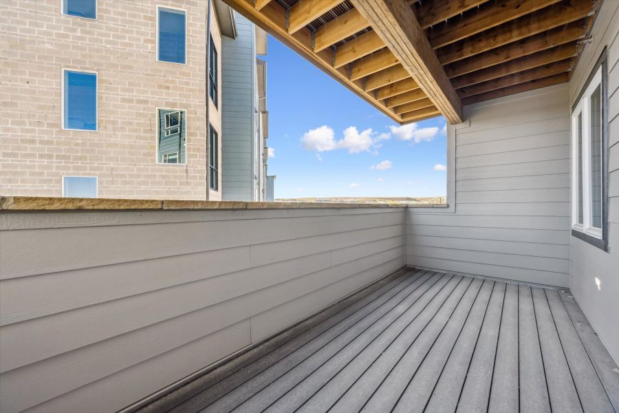 A wooden deck next to a building. A wooden deck next to a building.