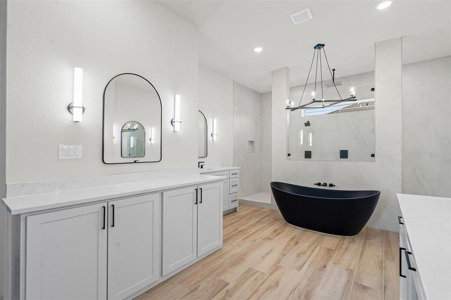Bathroom featuring vanity, a soaking tub, light wood-style flooring, walk in shower, and recessed lighting Bathroom featuring vanity, a soaking tub, light wood-style flooring, walk in shower, and recessed lighting