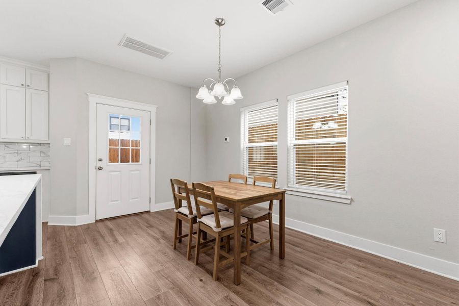 Enjoy dining in this inviting space with modern finishes. Easy access to the covered patio for seamless indoor and outdoor living.