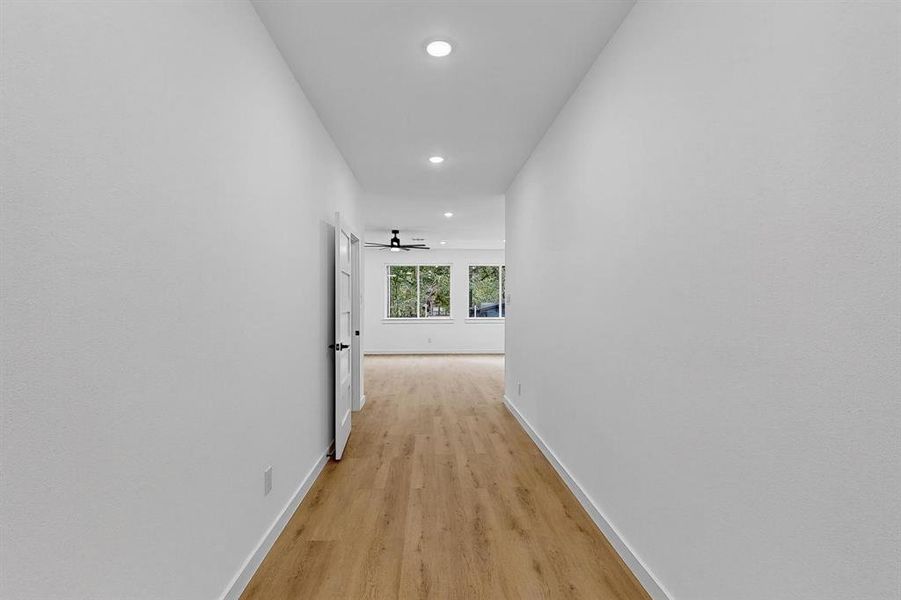 Hall featuring light wood-style floors and recessed lighting Hall featuring light wood-style floors and recessed lighting