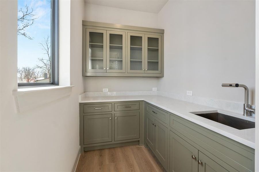 Butlers pantry with sink, window and lake view