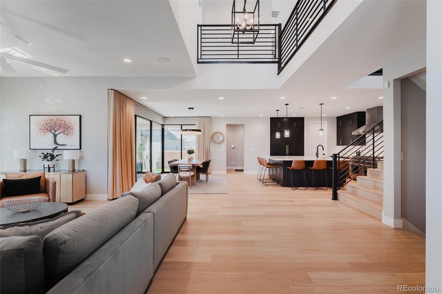 Modern white oak floors, extending gracefully across all three levels, are a true masterpiece of craftsmanship, weaving a harmonious flow throughout the home.